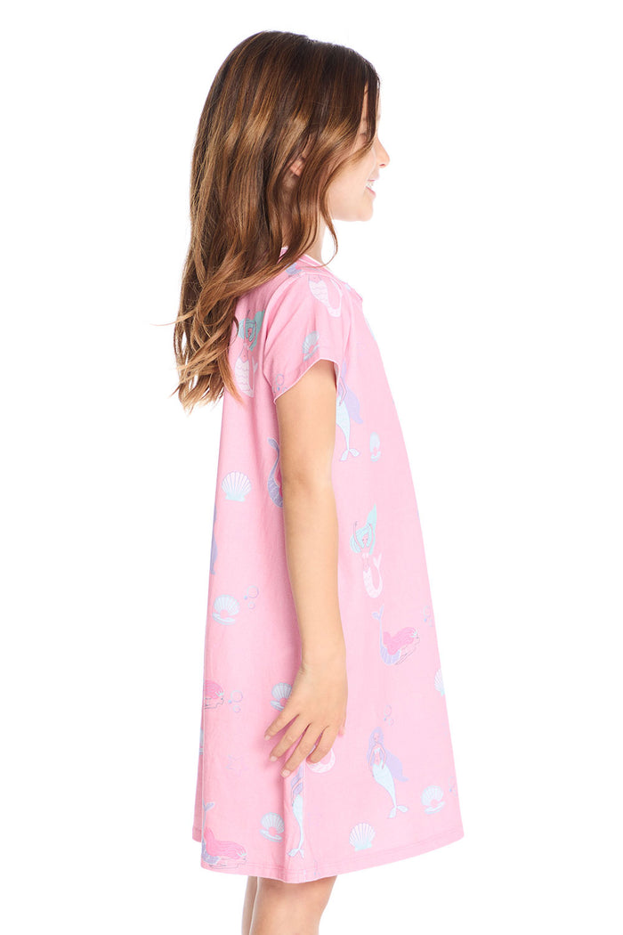 Side view of the Chaser Kids Mermaid Shells Shirt Dress showing the relaxed short sleeve fit and flared hem