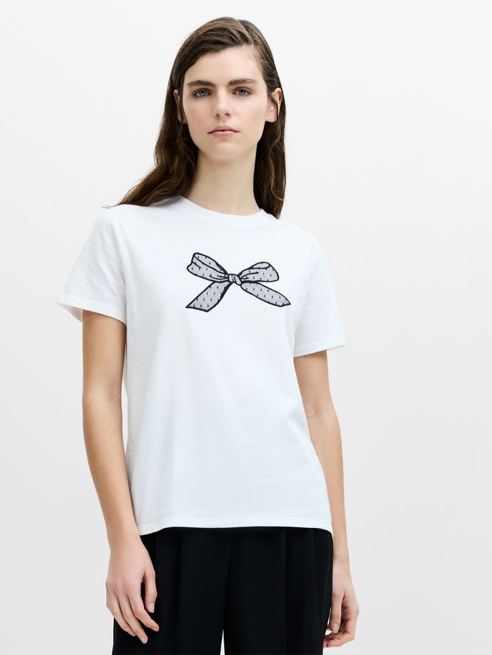 A woman wearing a white regular fit T-shirt with a crew neckline, short sleeves and a mesh bow detail.