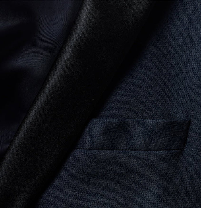 Close-up of midnight tuxedo jacket black satin shawl lapel and welt chest pocket