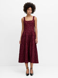 A woman wearing a burgundy floral jacquard midi dress with a square neckline, invisible back zip and fit and flare silhouette.