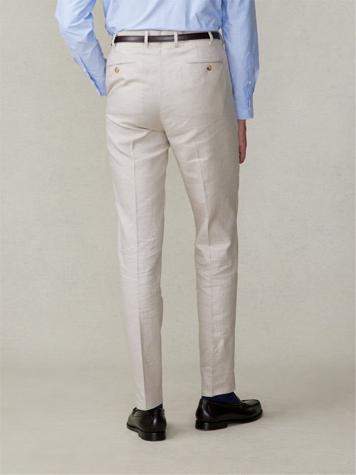 Back view close-up of man in mojave tan linen pleated pants with belt, light blue shirt