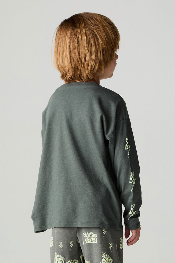Back view of a boy wearing the Chaser Monster Truck Boys Tee on a neutral background with pants