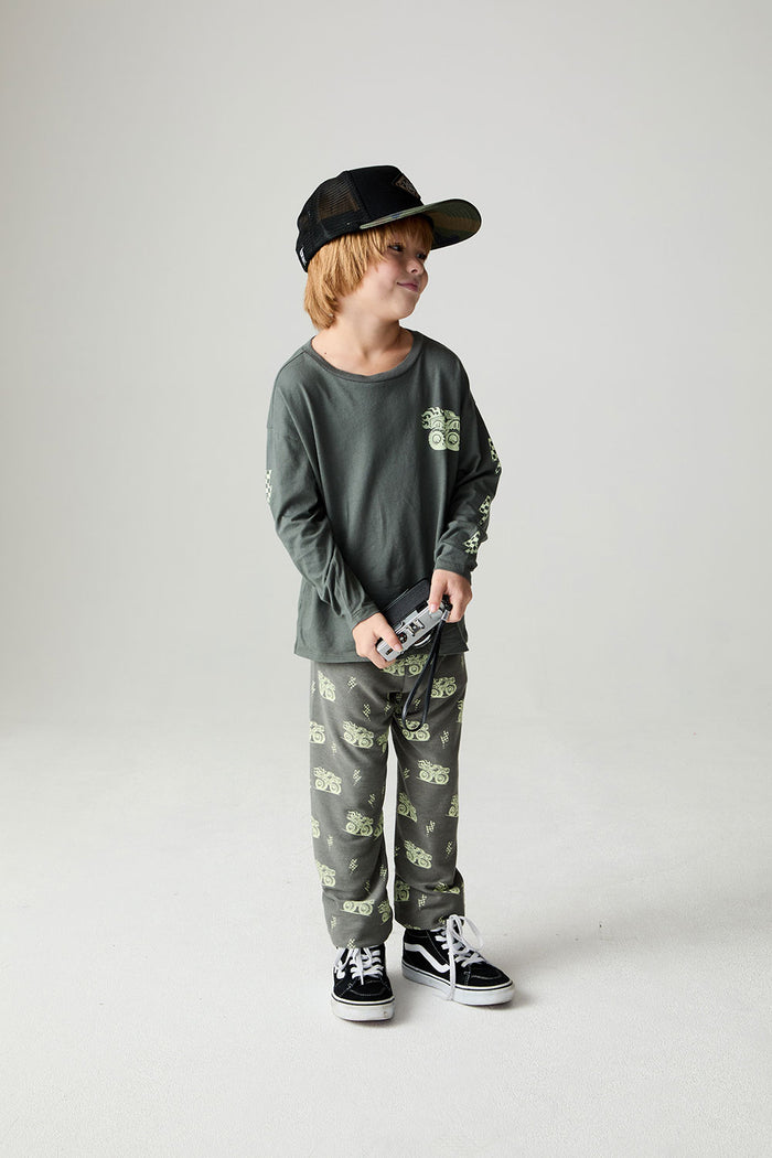 A full body front view of a boy wearing the Chaser Monster Truck Pants Boys Jogger on a neutral background