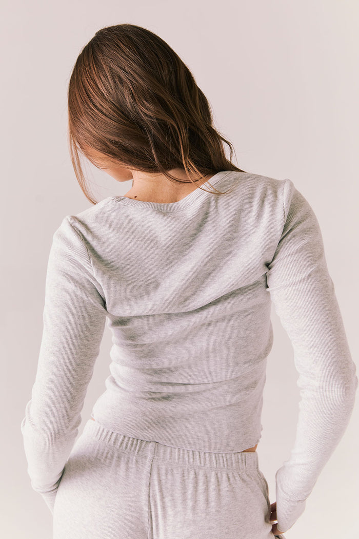 Heather grey ribbed long sleeve top with thumb holes and fitted shape.