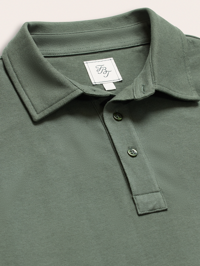 Close-up of moss green cotton pique polo shirt collar and two-button placket