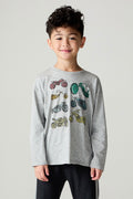 Front view of a boy wearing the Chaser Moto Boys Tee and black pants on a neutral background with hands at sides
