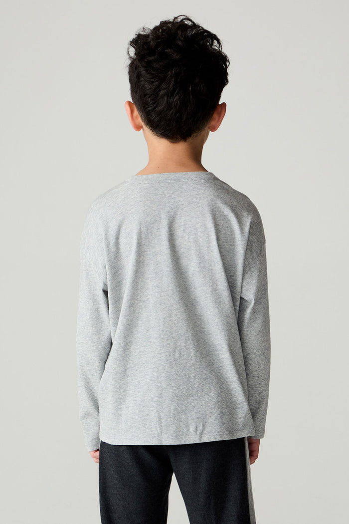 Back view of a boy wearing the Chaser Moto Boys Tee and pants on a neutral background
