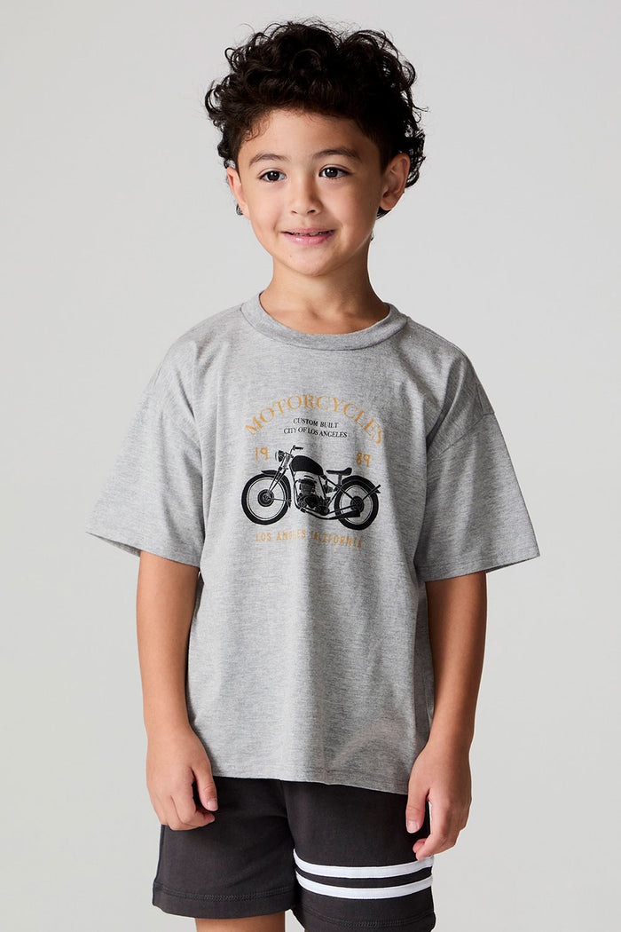 Front view of a boy wearing the Chaser  Moto LA Tee on a neutral background