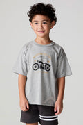 Front view of a boy wearing the Chaser  Moto LA Tee on a neutral background
