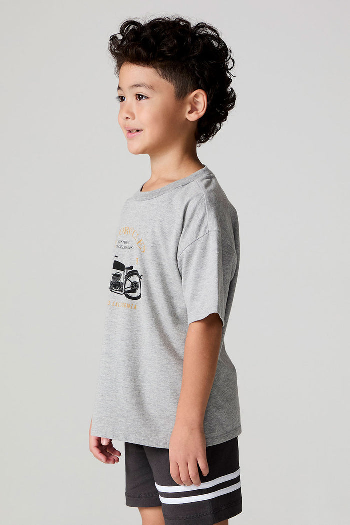 Side angle view of a boy wearing the Chaser  Moto LA Tee on a neutral background