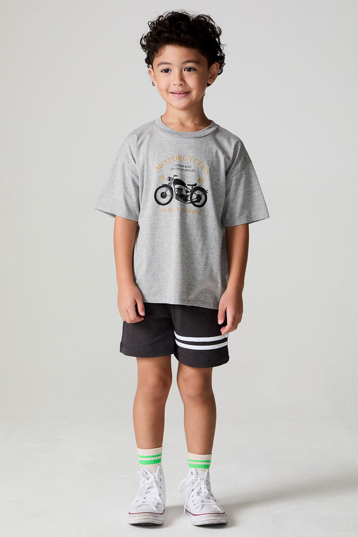 Full body front view of a boy wearing the Chaser  Moto LA Tee on a neutral background