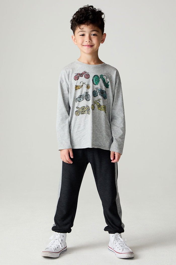 Front view of a boy wearing the Chaser Moto Pants Boys Jogger and matching tee on a neutral background