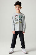 Front view of a boy wearing the Chaser Moto Pants Boys Jogger and matching tee on a neutral background