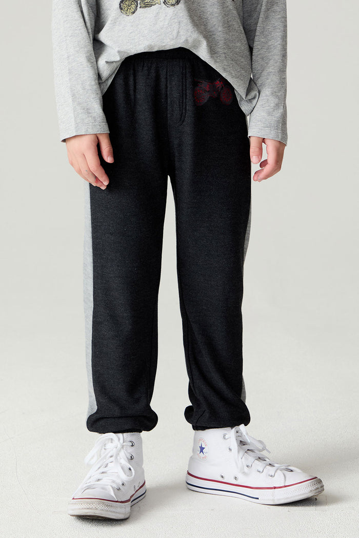 Front view of a boy wearing the Chaser Moto Pants Boys Jogger and white sneakers on a neutral background