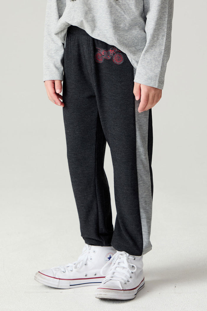 Side angle view of a boy wearing the Chaser Moto Pants Boys Jogger on a neutral background