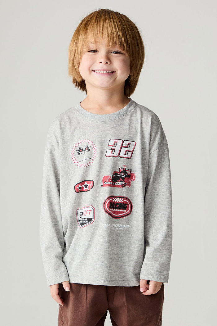 Front view of a boy wearing the Chaser Moto Patches Boys Tee on a neutral background with arms lowered at sides