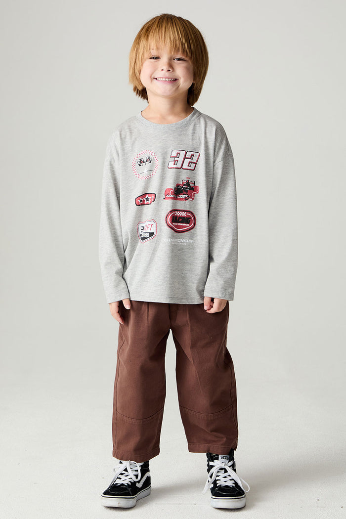 A full body front view of a boy wearing the Chaser Moto Patches Boys Tee on a neutral background