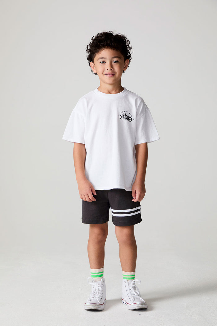 Full body front view of a boy wearing the Chaser  Motor Racing Tee on a neutral background