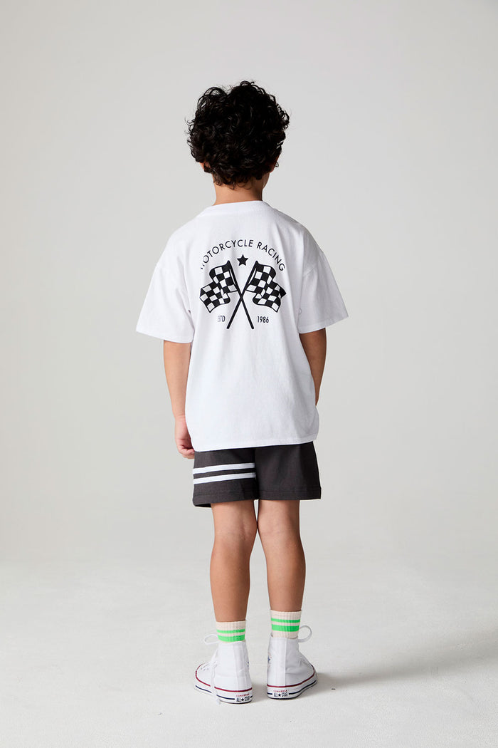 Full body back view of a boy wearing the Chaser  Motor Racing Tee on a neutral background