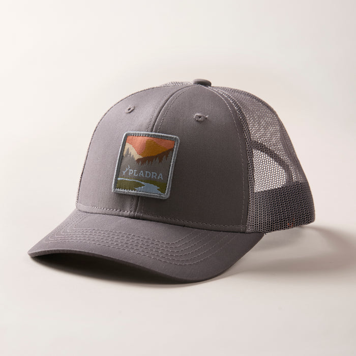 Mountain Trucker Hat in Charcoal Grey, a mid-crown grey mesh cap with a mountain landscape patch and adjustable snap back.