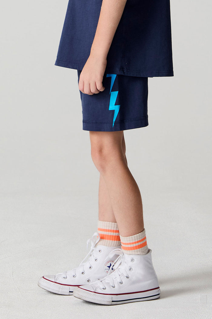 Side view of a boy wearing the Chaser Multi Bolt Shorts on a neutral background
