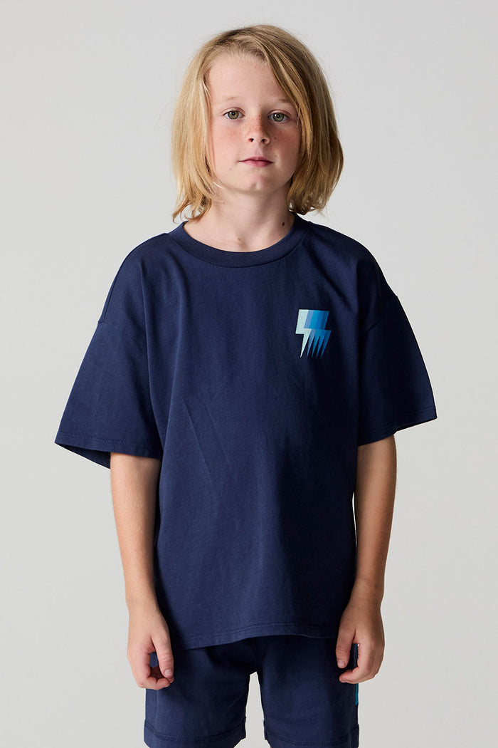 Front view of a boy wearing the Chaser Multi Bolt Tee on a neutral background