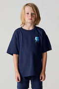 Front view of a boy wearing the Chaser Multi Bolt Tee on a neutral background