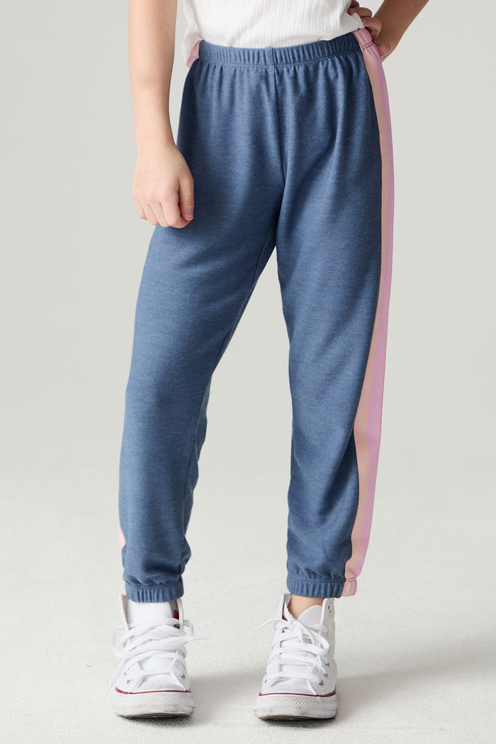 Front view of a girl wearing the Chaser Multi Stripes Girls Jogger on a neutral background with hand on hip