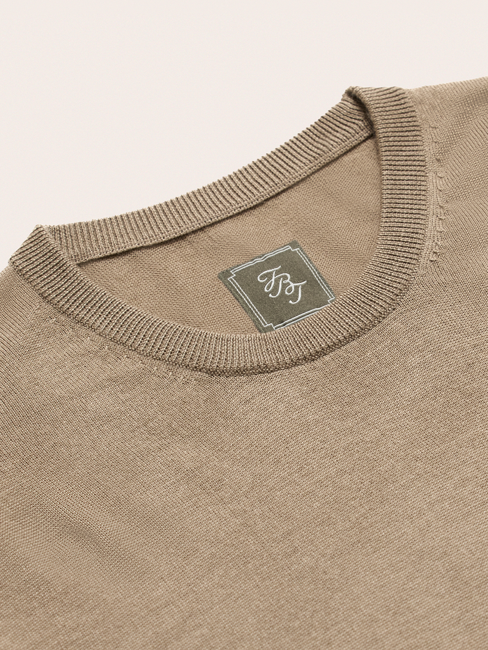 Close-up of mushroom brown sweater knit tee crew neckline and brand label