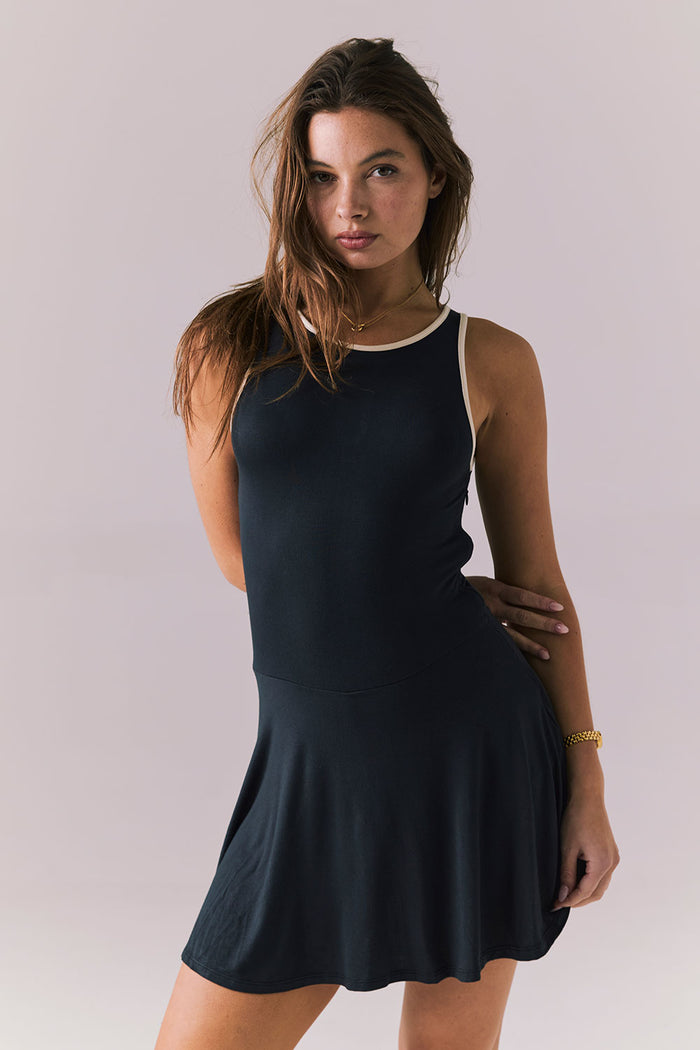 Front detail view of Chaser Brand Myrina Licorice Black Mini Dress showing the contrast neckline and smooth fitted bodice