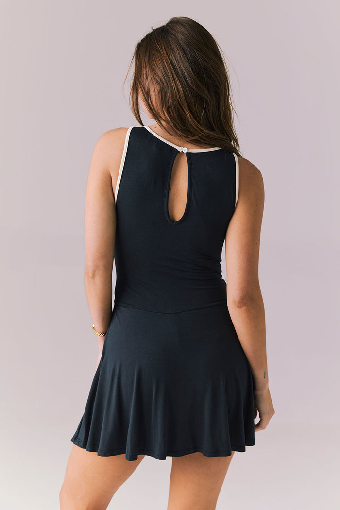 Back view of Chaser Brand Myrina Licorice Black Mini Dress featuring the keyhole opening and clean contrast trim