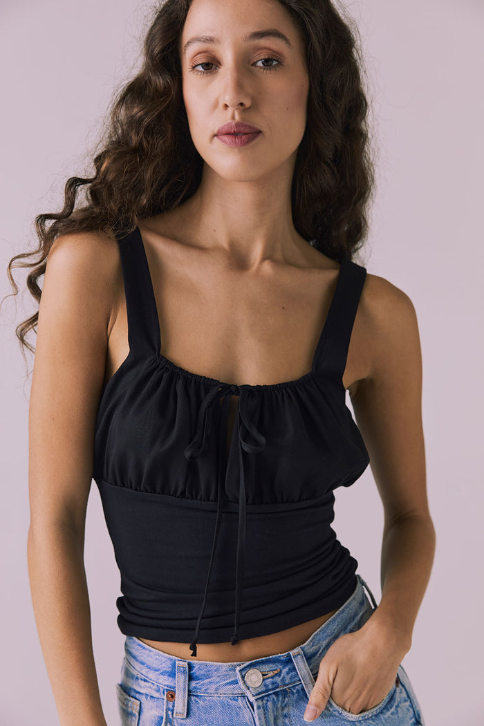 Chaser Nancy Tank in Black shown from the front with a fitted waist and subtle ruching across the bust