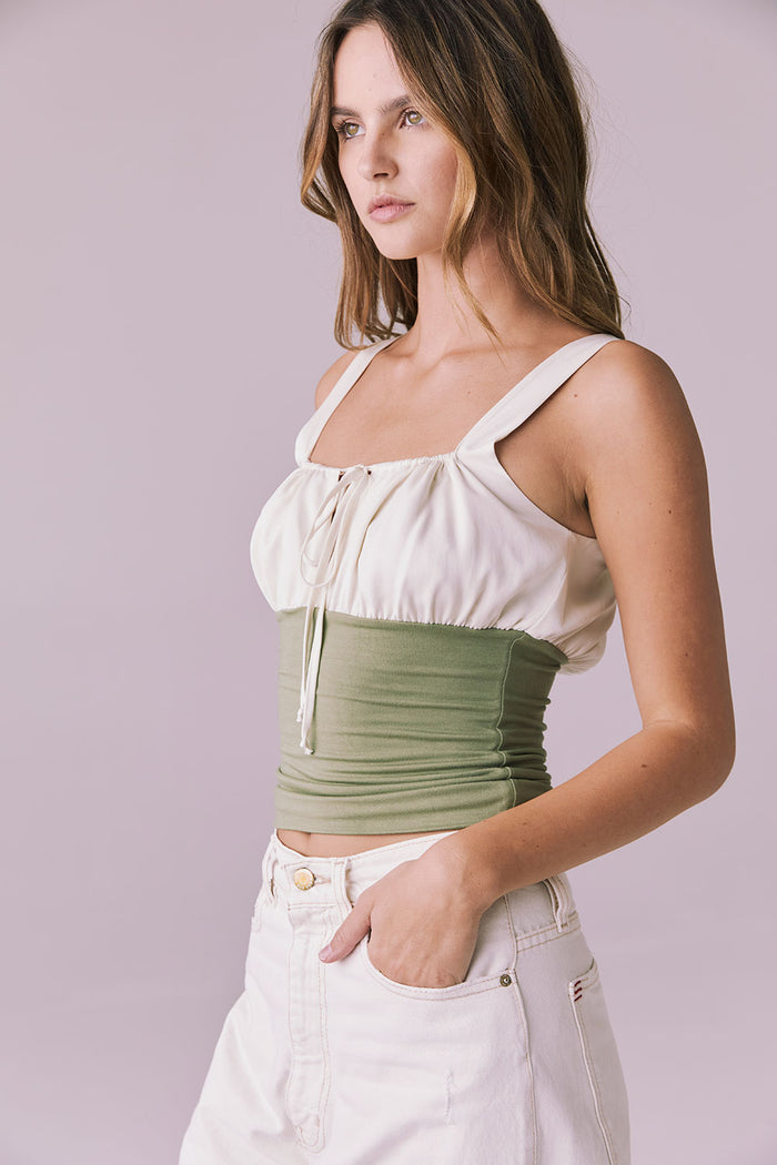 Side angle of the Chaser Nancy Meadow Green Tank with soft ruching and contrast ivory top panel
