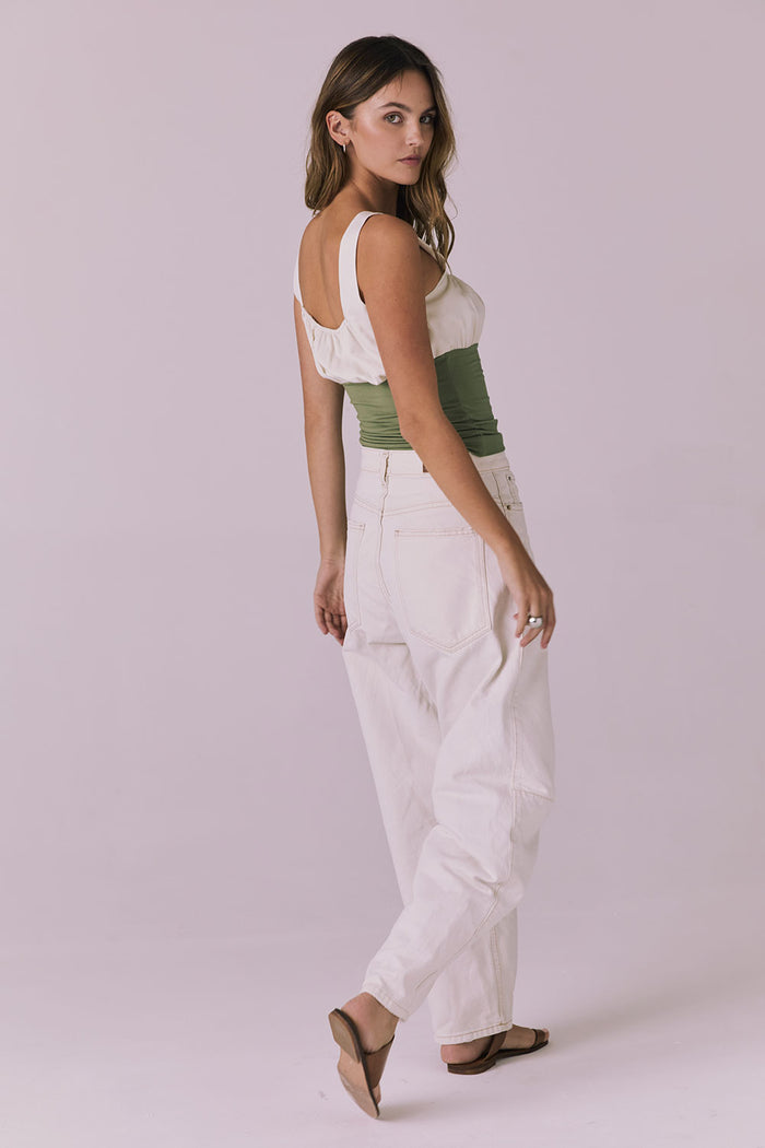 Full body back view of the Chaser Nancy Meadow Green Tank styled with loose white pants showing the low back scoop and easy movement