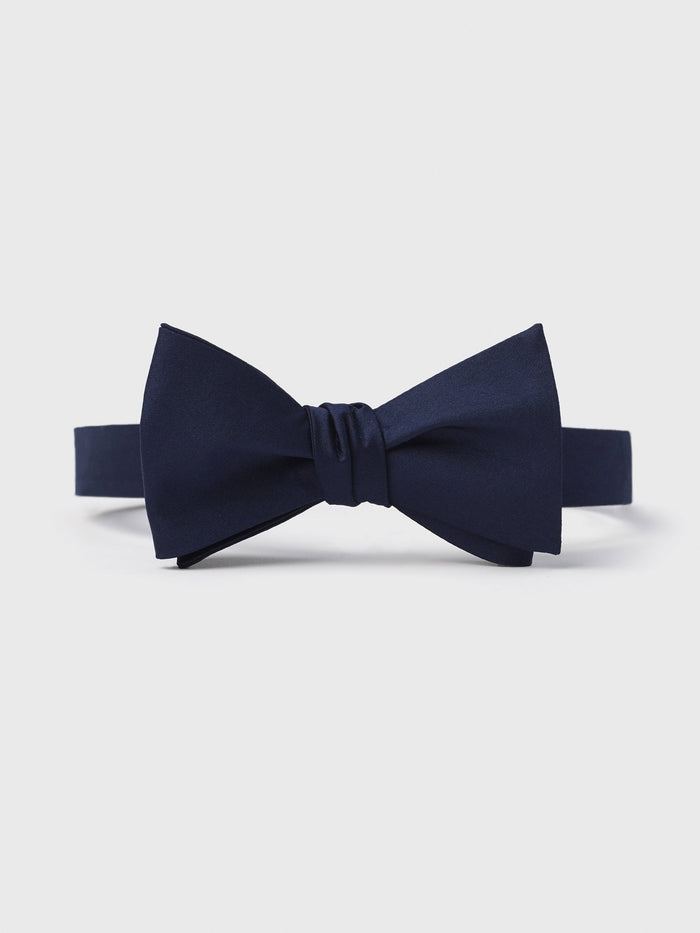 Navy self-tie butterfly bow tie, pre-tied, on light grey background