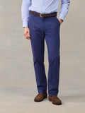 Close-up of man in navy chino pants with brown belt, light blue striped shirt, front view