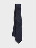 Navy pinstripe linen necktie hanging against a light grey background