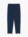 A man wearing navy Piqué tailored trousers with 4 pockets, a zip fly fastening and a front pressed crease.