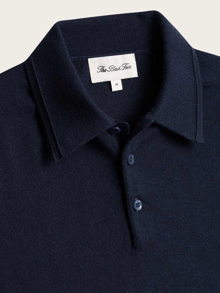 Close-up of navy polo sweater collar and three-button placket with brand label