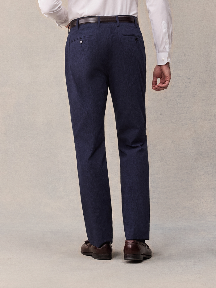 Back view close-up of man in navy seersucker suit pants with brown belt