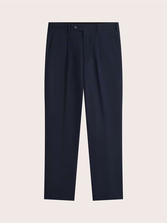 Navy seersucker suit pants laid flat, pleated front