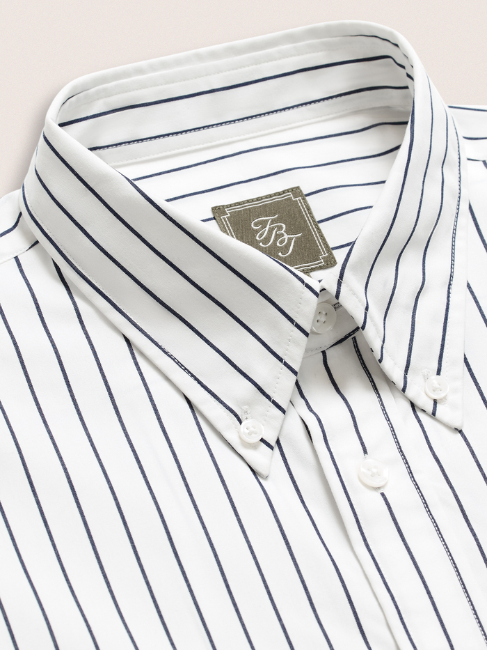Close-up of white and navy striped dress shirt collar and brand label
