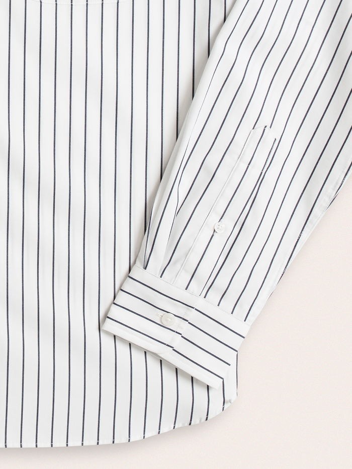 Close-up of white and navy striped dress shirt cuff and sleeve placket