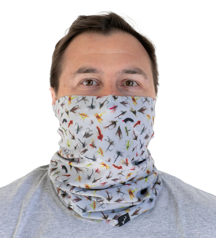 Man wears Pladra Neck Gaiter- Flies Print, featuring cooling tech and moisture-wicking for comfort.