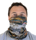 Neck Gaiter in River Landscape Print, showing fish, birds, bears, and deer, worn over the neck and lower face.