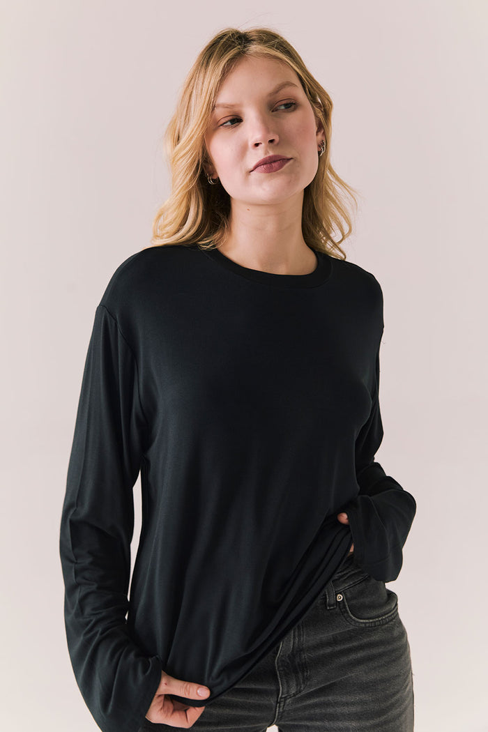 Oversized black long sleeve top with dropped shoulders and relaxed silhouette.