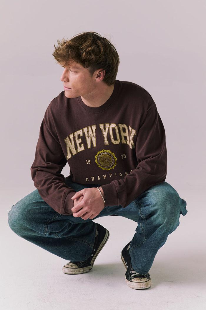 Full body of model in Kahlua Brown New York 1975 long sleeve tee.