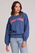 Front view of a woman wearing the Chaser New York Tee on a neutral background