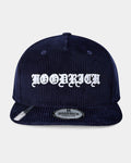 Navy blue corduroy cap with white text on a light gray background