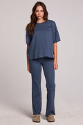 A full body front view of a woman wearing the Chaser Noorh Dark Denim Pants